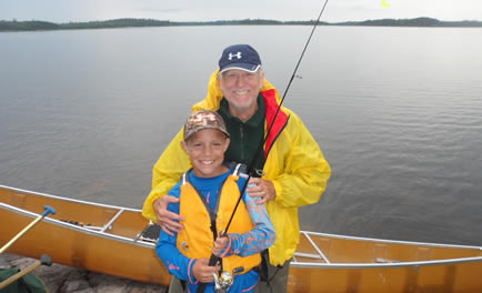 posing in front of a canoe